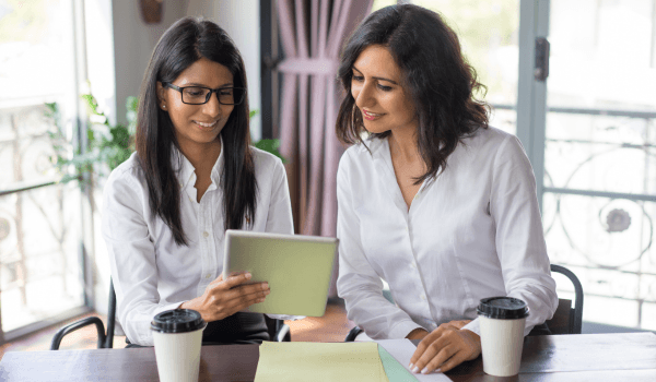 Women professionals collaborating in a modern workspace reflecting the supportive environment of the best coworking space in Bellandur for women