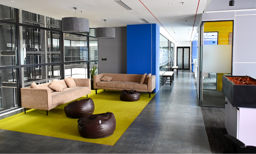 Modern coworking lounge area reflecting Coworking Design Trends with natural light, collaborative seating, and flexible workspace design at The Yard