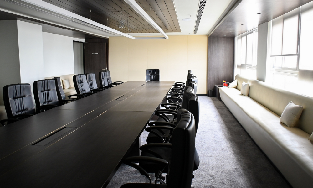 Conference room setup for client meetings in coworking space with large table and executive seating
