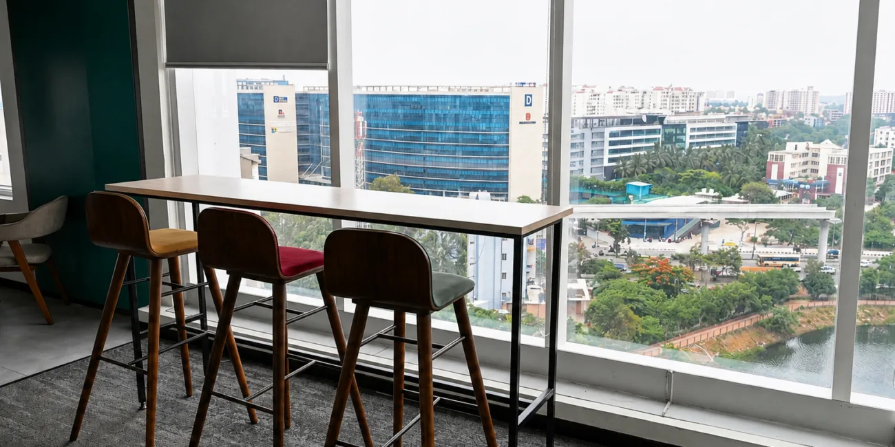 Managed office space in Bengaluru with modern high chairs and panoramic city views