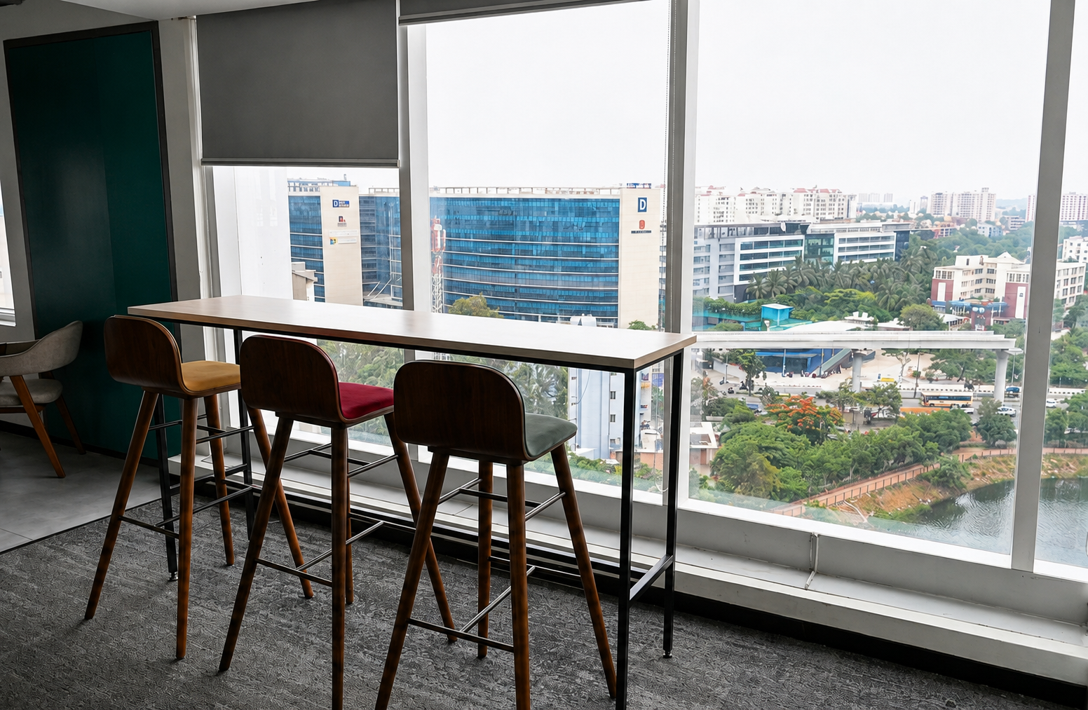 Managed office space in Bengaluru with modern high chairs and panoramic city views