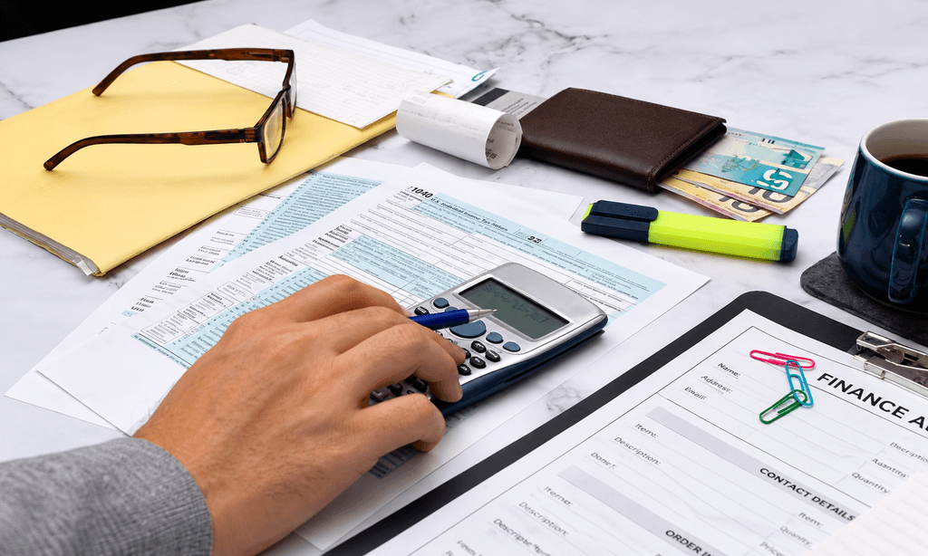 Calculating income tax return with tax form and calculator for coworking expense deductions