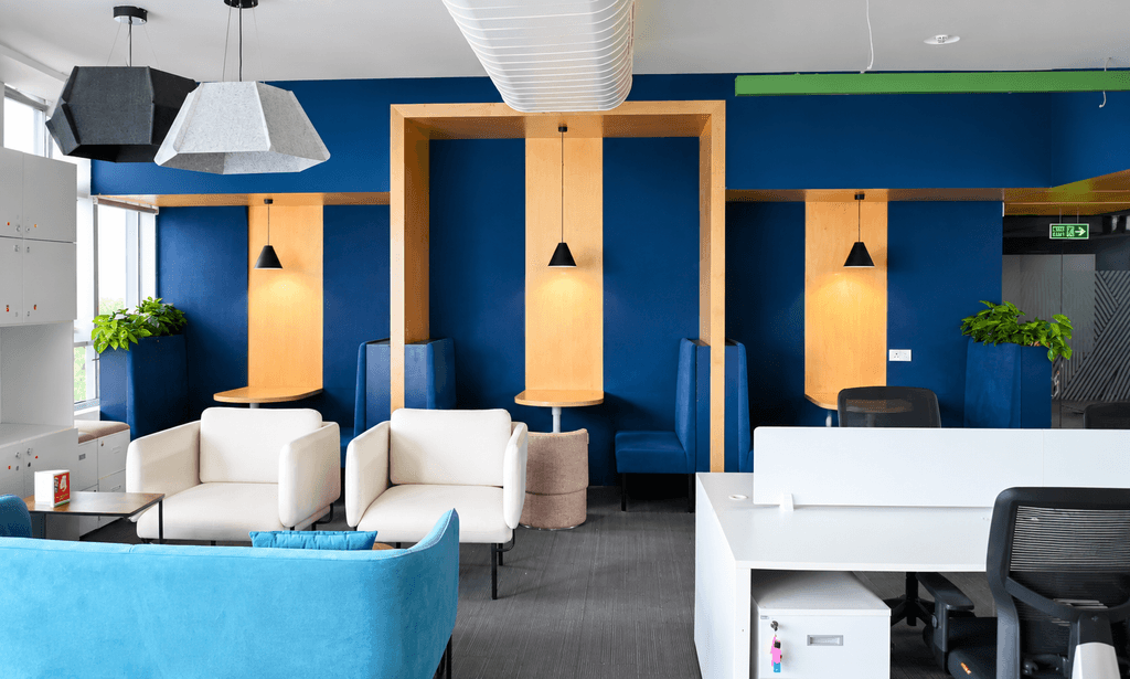 Lounge seating booths and open desk area at The Yard coworking space
